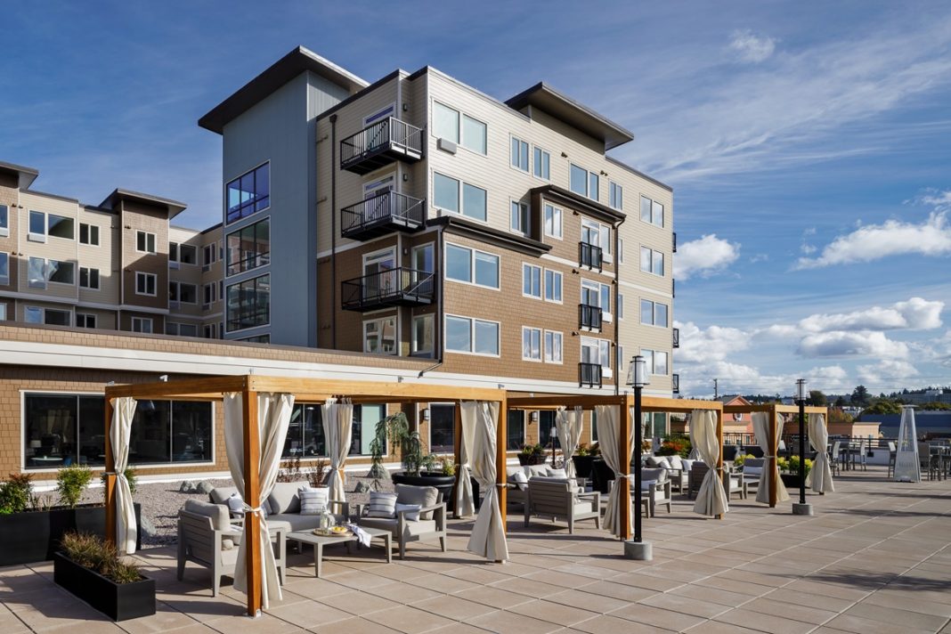 Exterior of rooftop area with tables and pergolas at Harbor Heights