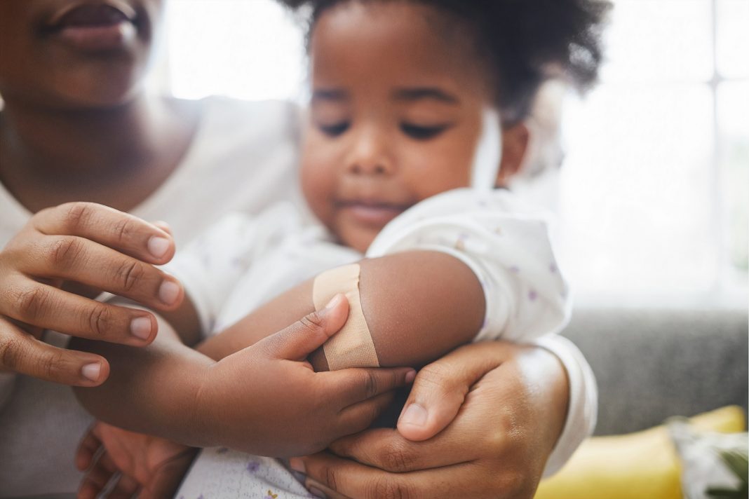 a toddler in a person's arms