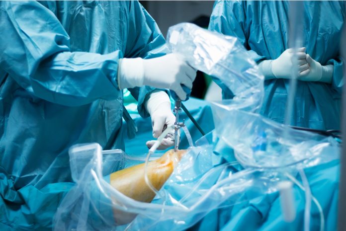 OlyOrtho-trauma-surgery surgeeons in blue gowns performing surgery