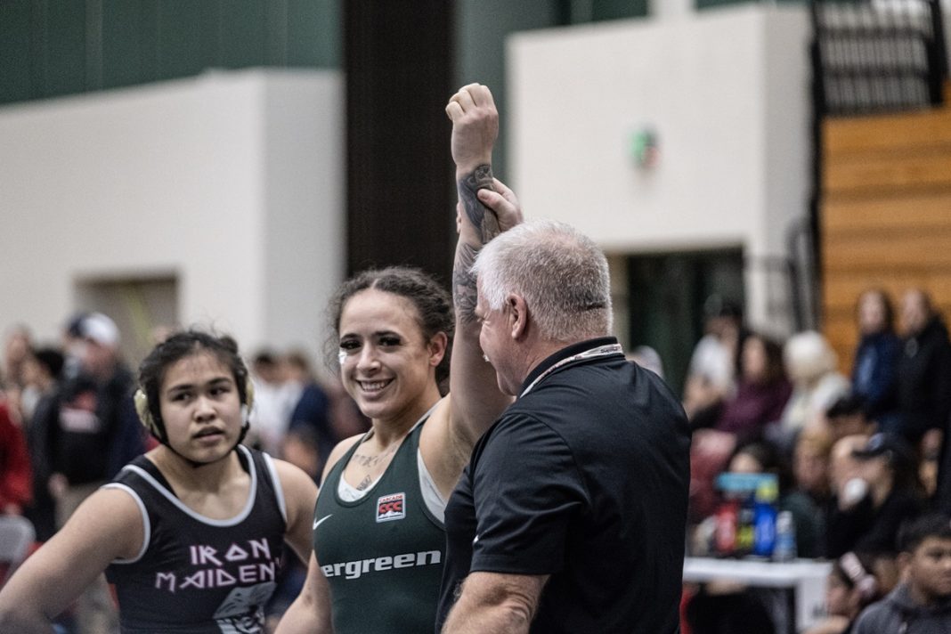 Flor Parker Borrero with a wrestling referee holding up her arm