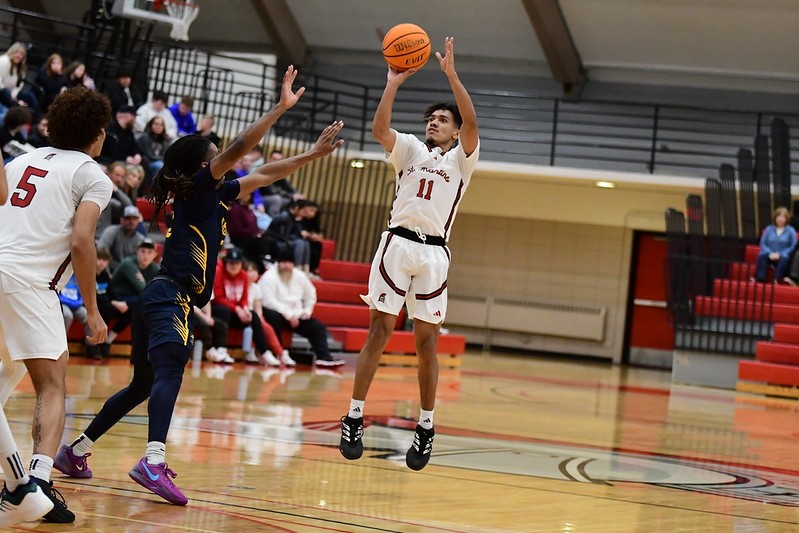 Saint Martin's University men's basketball team playing against another team on a court