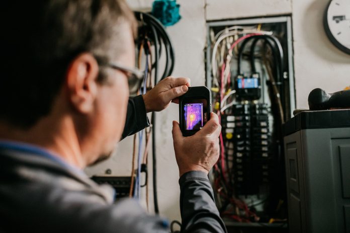 Boggs-Inspection-Services-electrical-safety-Electrical-Panel-Infrared Boggs Inspection Services tech looking at wiring on a home