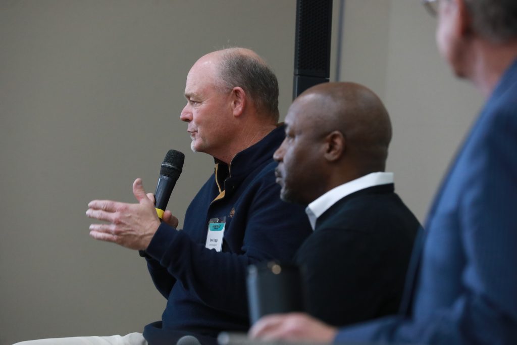 Speaker Dave Scaggs talking into a microphone