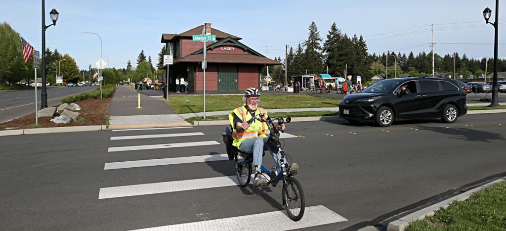 adult on a bike crossing a street