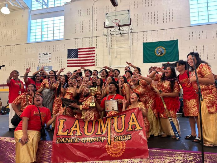 Laumua Youth Samoan Dance Group (2) Laumua Samoan Dance Group sitting on bleachers in red team shirts and black shorts with a banner that says Lauma Dance Group. One is holding a trophy and a plaque. All of them are shouting at the camera with hands raised