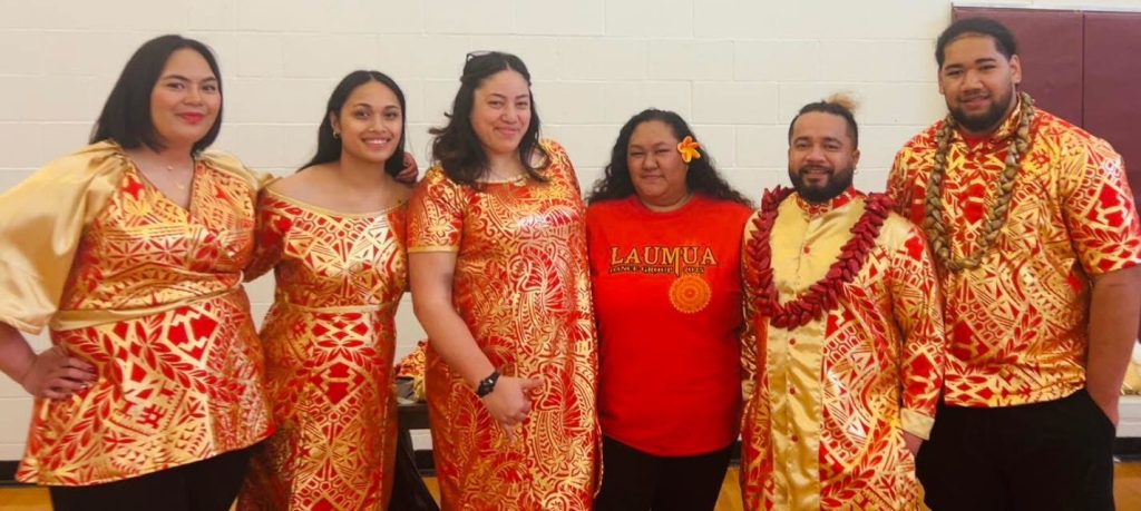 Laumua Samoan Dance Group members in red and gold Samoa outfits for competition