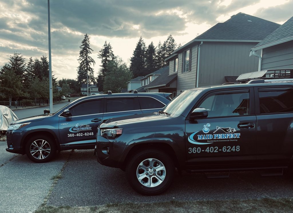 two suvs with the Maid Perfect logo on it and 360.-402-6248