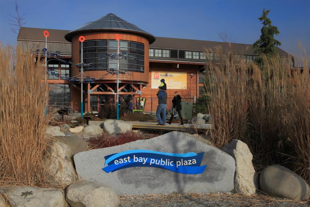 outside of Hands on Children's Museum building with a sign on a rock that says East Bay Public Plaza