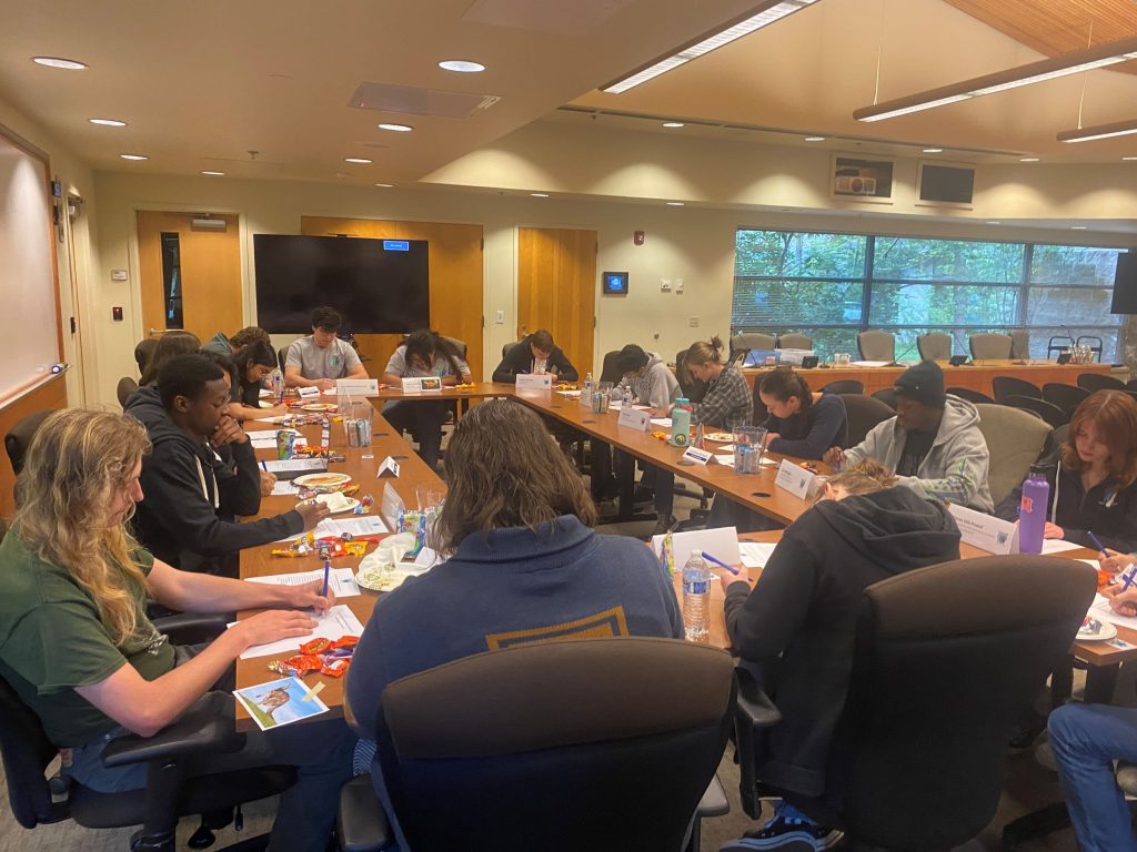 City of Lacey Youth Council meeting together in a meeting room at long rectangle tables pushed together to form a bigger rectangle