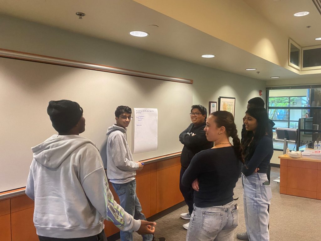 6 lacey youth council taking together in a meeting room