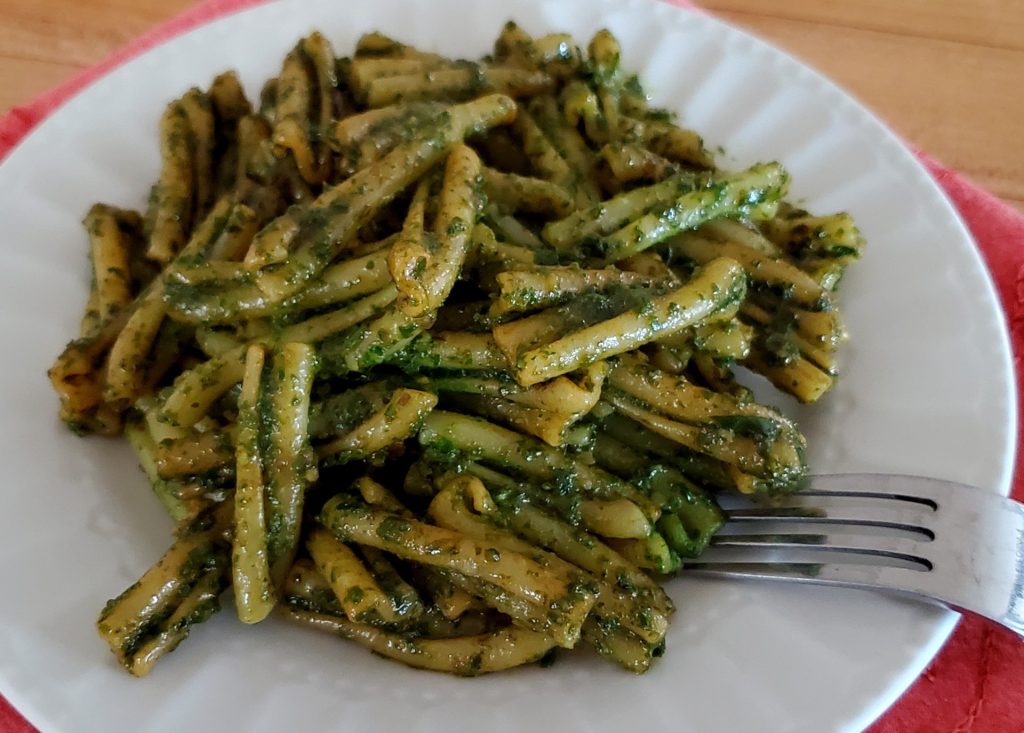 noodles with pesto on a plate with a fork