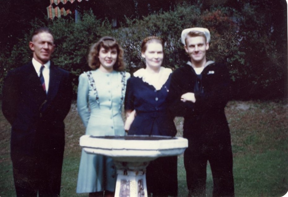 Arleen (second from right) with her parents (left, second from left) and brother Wayne. Wayne (far right) pose for a photo by a birdbath. Warne is wearing his sailor uniform