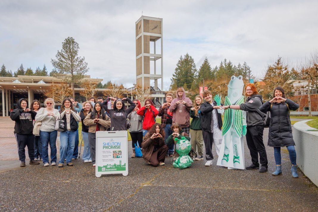 Shelton Promise students visit The Evergreen State College campus and pose for a photo with the bell tower in the background