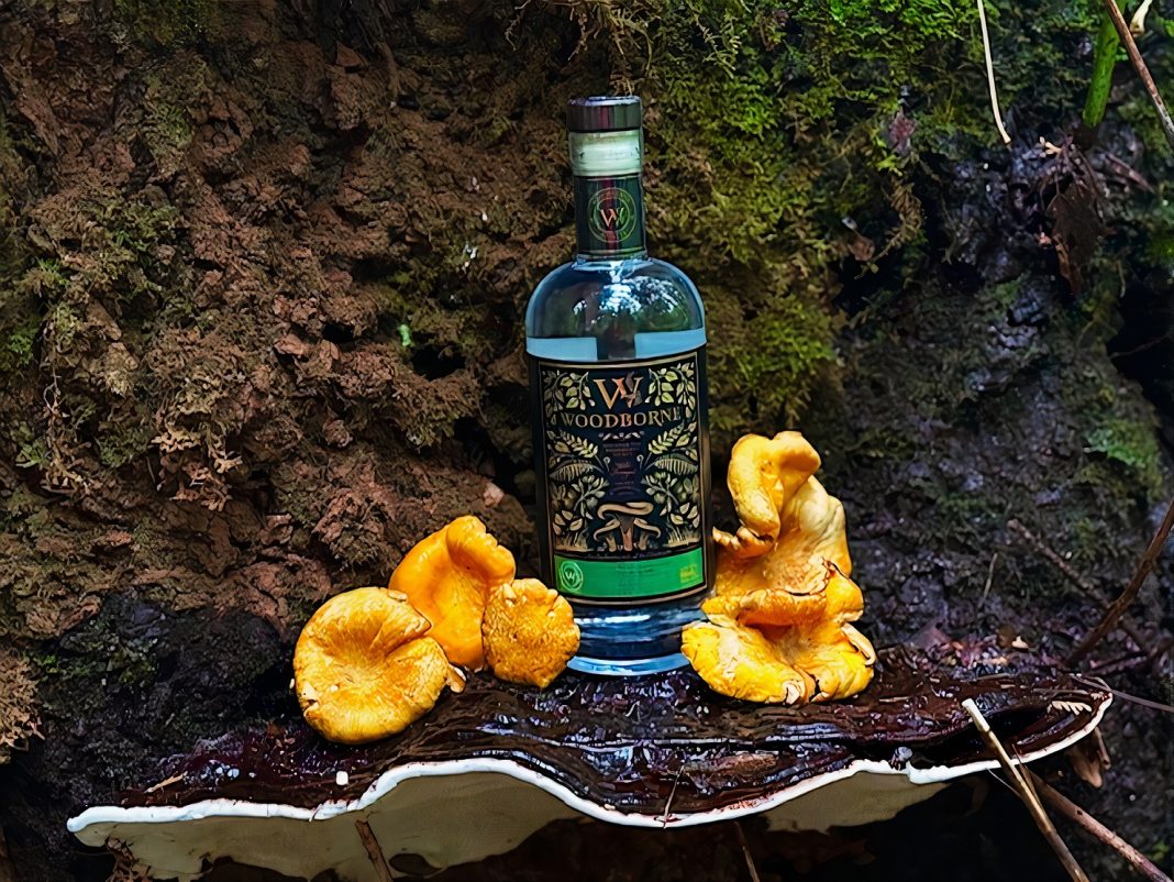 a bottle of Woodborne Spirits vodka with chantrelle mushrooms lying around it