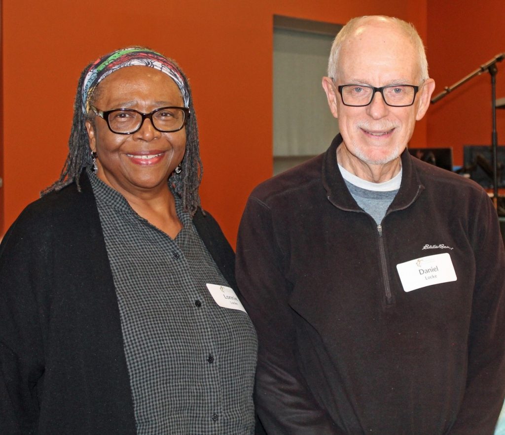 Lonnie Locke (left) with Dan, her husband (right) stand next to each other