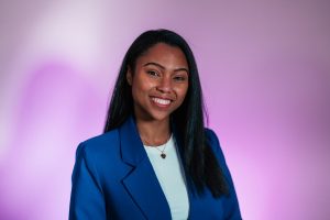Tamara Erazo, headshot against a purple and white background