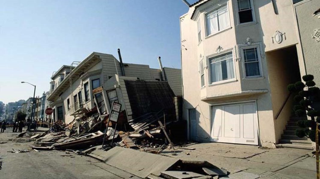 a house falling into the street after an earthquake