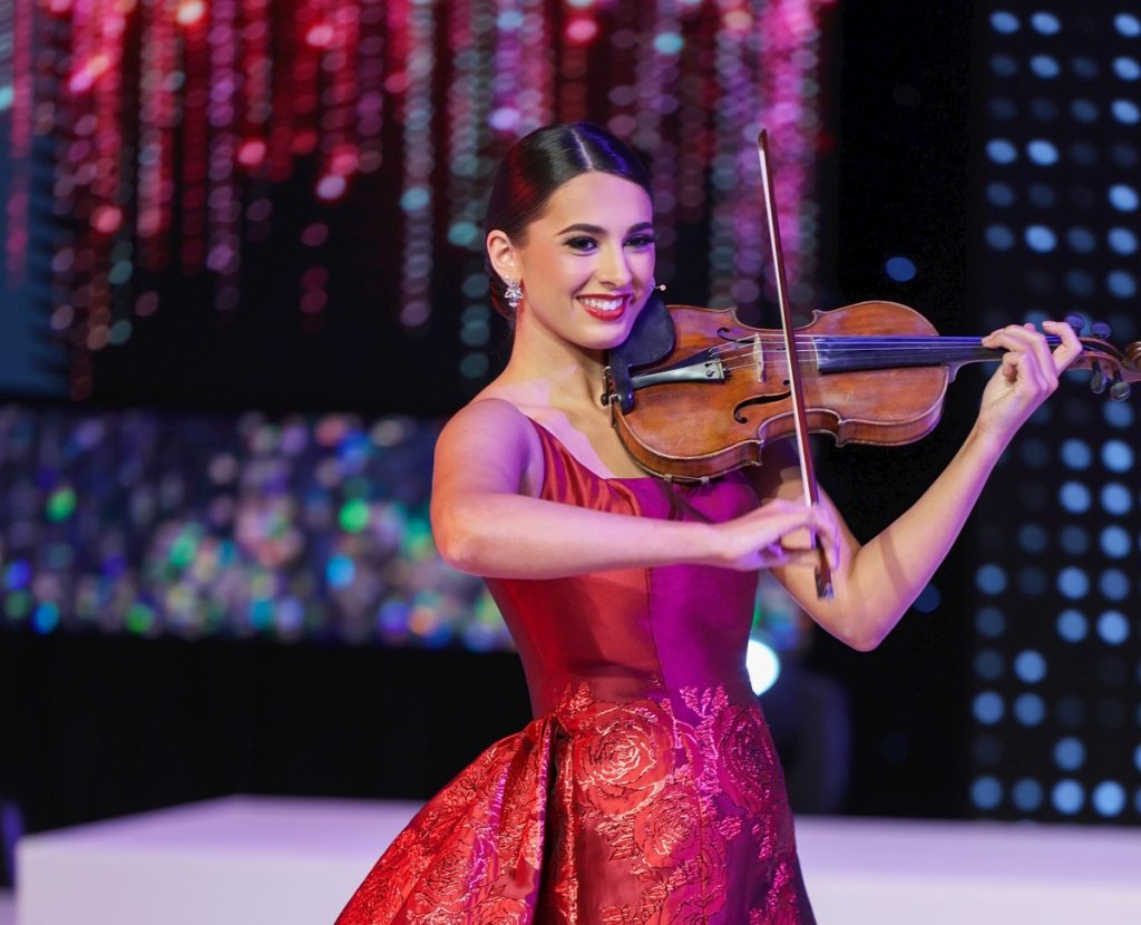 Miss Washington 2025 Amber Pike playing her violin in a red evening gown