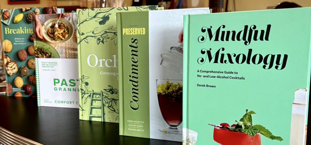 a row of cookbooks on a shelf
