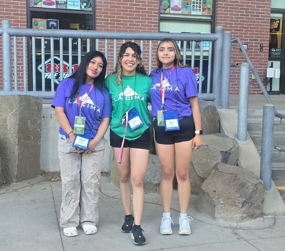 three latina girls standing outside a brick building in LA CIMA shirts