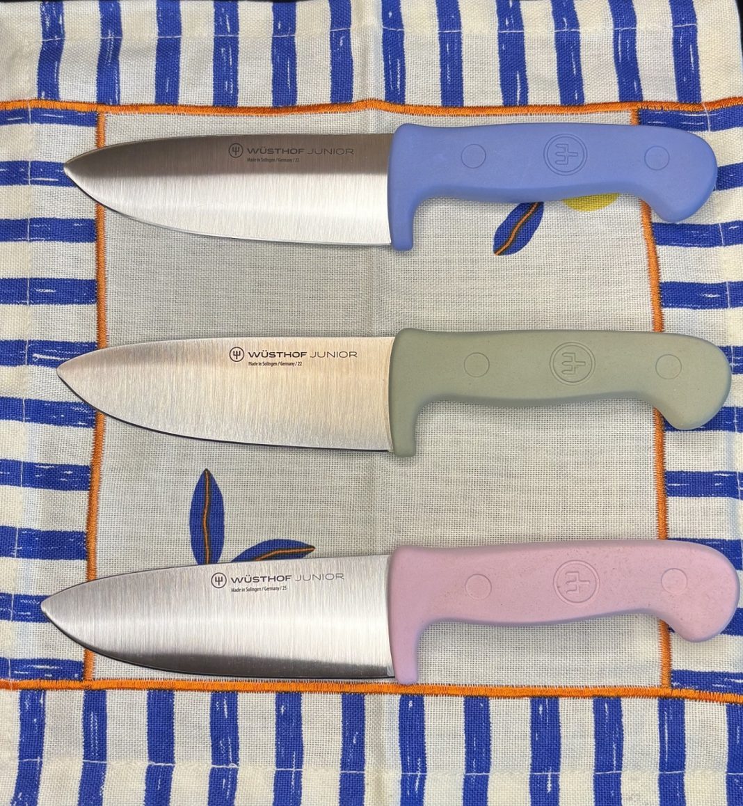 three wusthof junior knifes laying in a row on a towel
