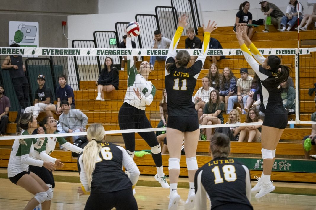 Evergreen State College volleyball team playing a game against another college team.