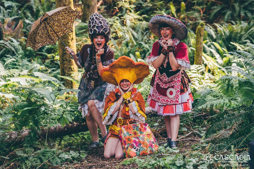 three woman in fantasy mushroom outfits in a forest